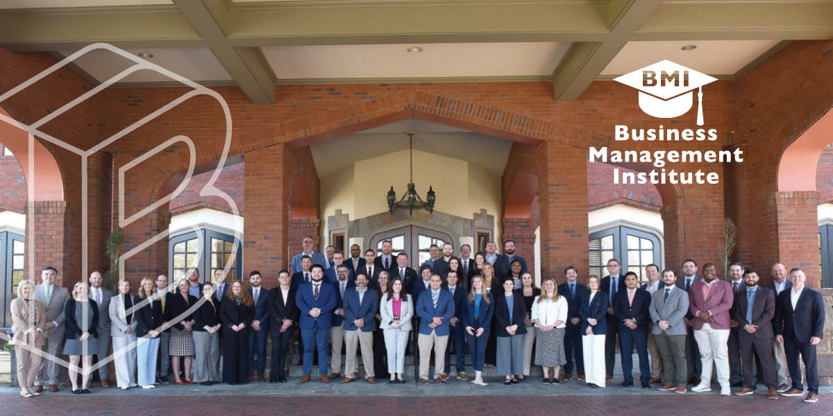 Banner: Attendees at a BMI course pose together for a photo