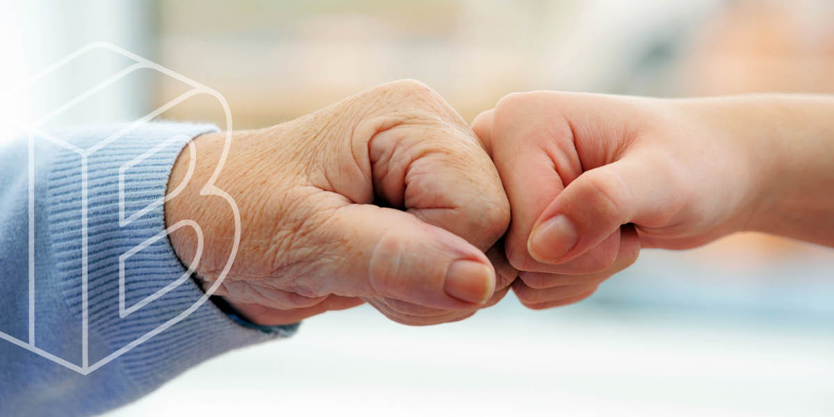 Banner image: Two people bumping their fists together