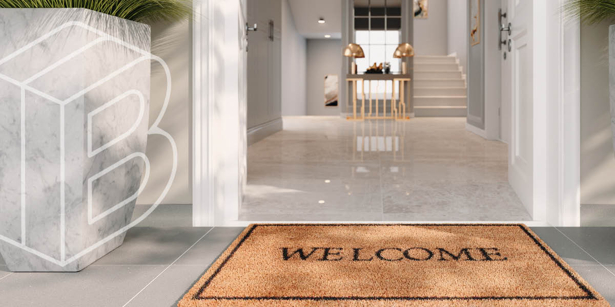 Image of a doorway with a welcome mat in front of it