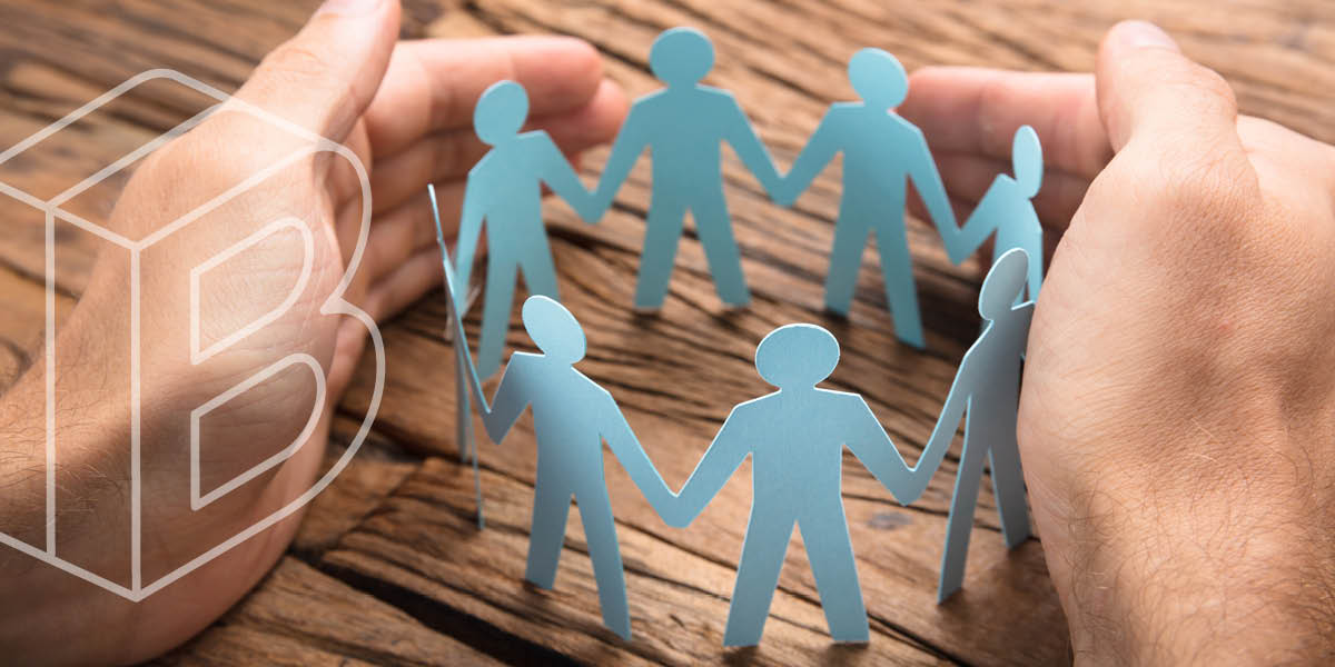 Banner: A circle of paper figures holding hands, encompassed between two human hands