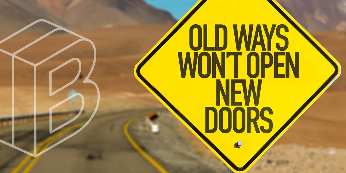 Image of a road with a road sign in front reading "Old ways won't open new doors"