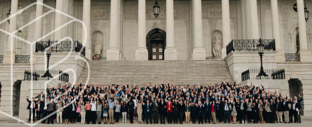 Banner image of the group of attendees standing in front of the Capitol building